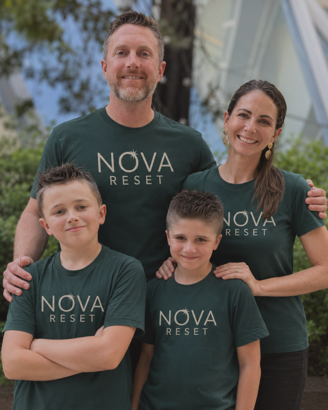 The NOVA RESET founding family wearing NOVA RESET shirts outside the Grand Island studio